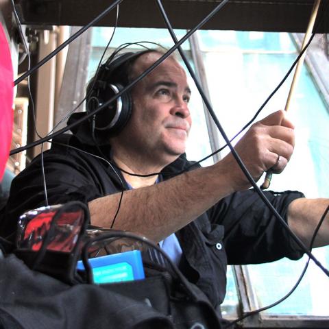 Joseph Bertolozzi performing on a bridge