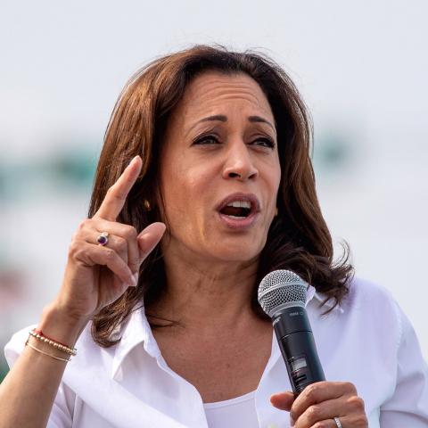 Image: Kamala Harris speaking, holding a microphone
