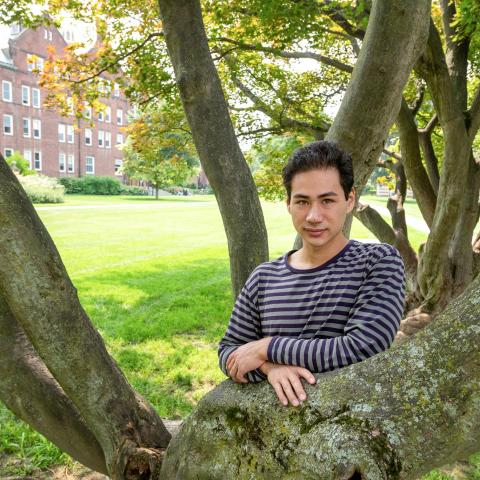 Ford Scholar Caleb Mitchell ‘22 among the stand of Japanese Maples at the center in the residential quad, which, he discovered, was initially proposed in 1931 by Olmsted partner Percival Gallager, in order to break up the diagonals formed by the paths.