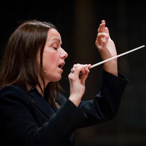 a closeup of music professor Christine Howlett conducting.