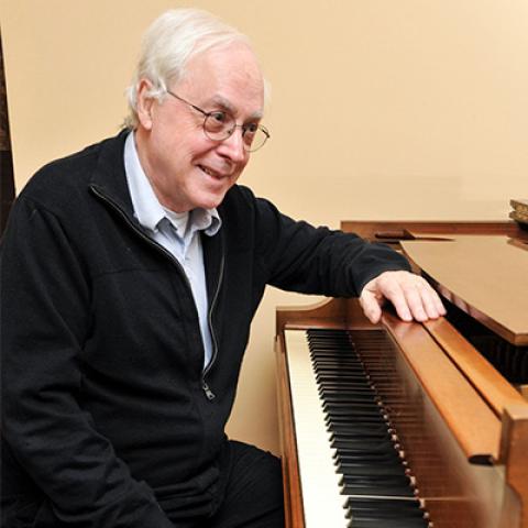 Richard Wilson seated at the piano.