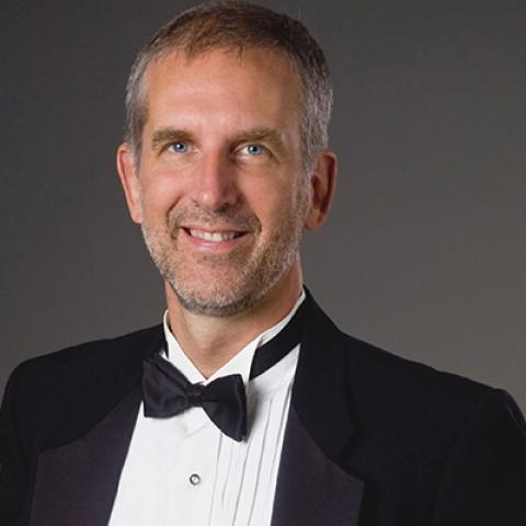 Music faculty member Robert Osborne wearing a tuxedo.