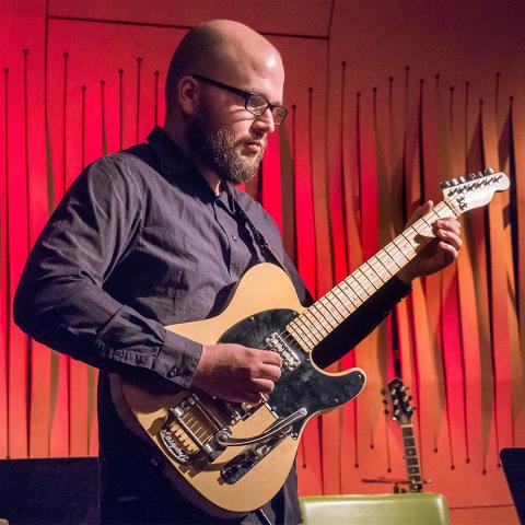 Music faculty member Trevor Babb playing guitar