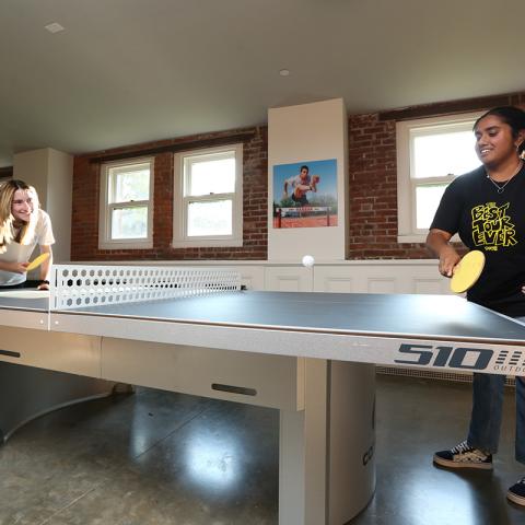 Davison residents Emmie Jensen ’25 (left) and Maryam Bacchus ’25 engage in a fierce ping-pong match in the new game room.