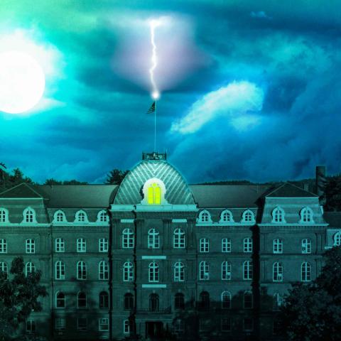 Night time over Vassar College Main Building as lightning strikes the top of the building
