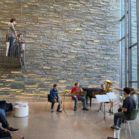 Four musicians performing in a large space