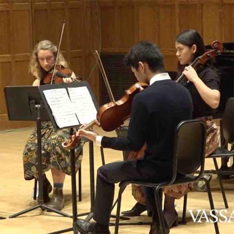 three musicians playing stringed instruments