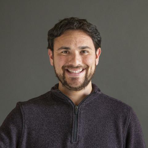 Man with black hair and a beard smiling - Pictured: Payton Small 