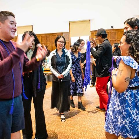 Ceremony where people are waiting in line to receive a purple transition cord.