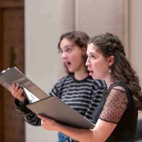 Two women singing in a choir