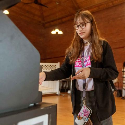 A person casting their ballot at a polling site.