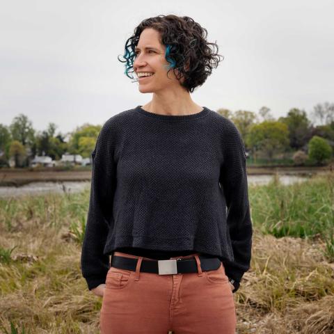 Mary Jane Rubenstein standing in a field.