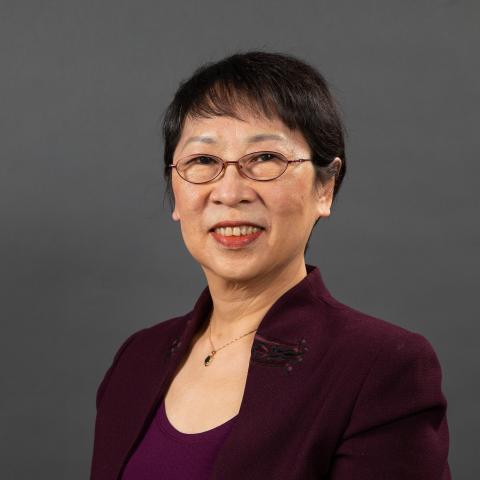 Peipei Qiu wearing a burgundy shirt and jacket.