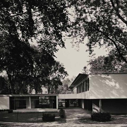 Vassar College, Ferry House Exterior in black and white - A white geometric building surrounded by trees.