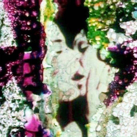 an image of degraded celuloid film, two women kiss with the damaged edges hand painted.