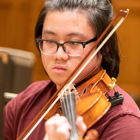 A violinist playing in a rehearsal