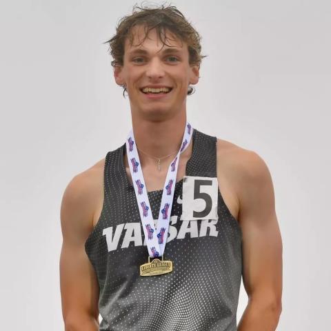 Smiling person in athletic gear wearing a Liberty League medal.
