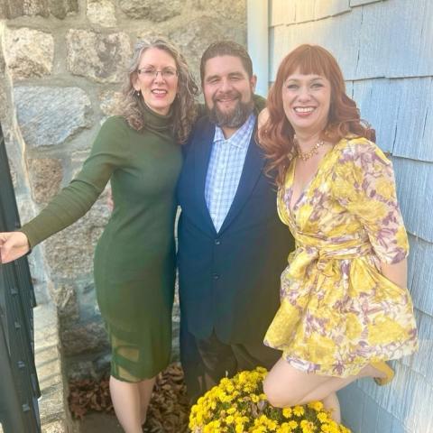 Group picture of three people smiling at the camera.