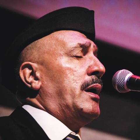 Detail of performer singing into a microphone.