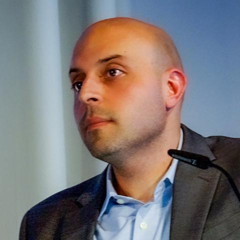 A person with a small microphone in from of them.