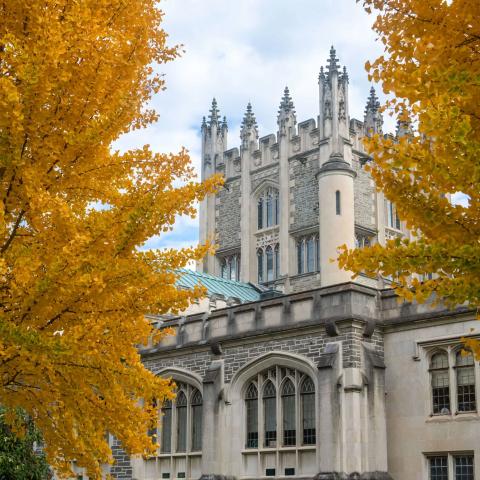 Exterior of a building nestled among fall foliage.
