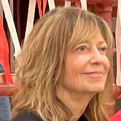 Pictured: Patricia Wallace. Person smiling and looking away from the camera.
