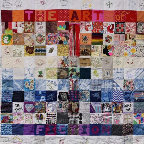 A patchwork quilt bordered by patches reading 'The Art of Fiction.'