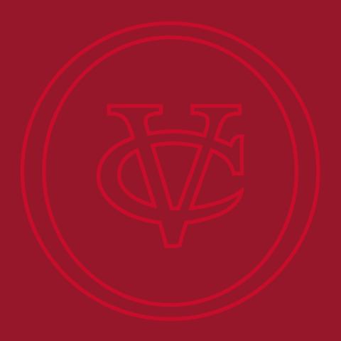  A close-up of a red background featuring an outlined logo composed of the interlocking letters "VC" inside of two concentric circles. The logo and circles are a lighter shade of red than the background.