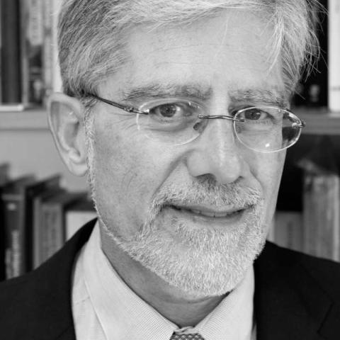 A black and white photo of Professor Kenneth Stow, a person with short gray hair, glasses, and a mustache and beard.