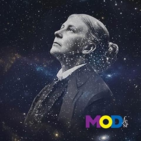 A figure gazes upwards against a cosmic background filled with swirling galaxies and stars, creating a sense of vastness. The figure is depicted in monochrome, wearing formal attire that contrasts with the vibrant celestial hues. The facial expression is contemplative, adding depth to the pose. In the lower right corner, the text “MODfest” is displayed in bold, colorful lettering.