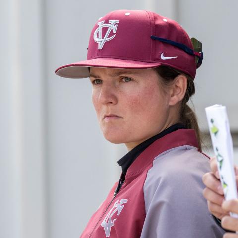 Person wearing a baseball cap staring off screen intensely.