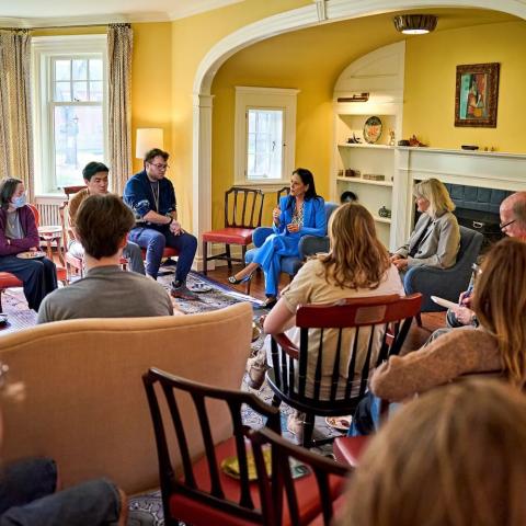People sitting in chairs in a circle having a discussion.