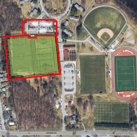 Aerial view showing the orientation of new sports fields and a parking lot, outlined and superimposed over the existing layout.