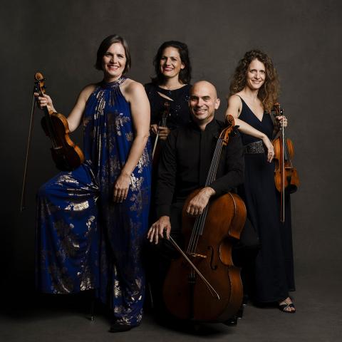 Four members of the Jupiter String Quartet pose with two violins, a viola and a cello.