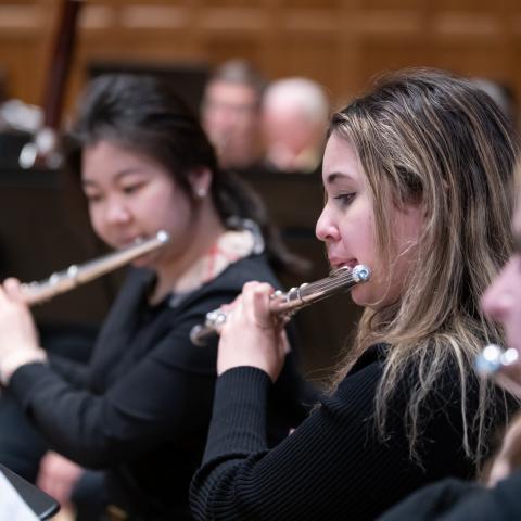 Student flutists perform with the Vassar College Wind Ensemble.