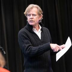 Willam H. Macy is directing a Masterclass and pointing to a script he is holding in his hand