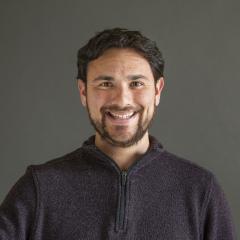 Man with black hair and a beard smiling - Pictured: Payton Small 